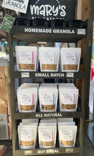 Mary's All Natural granola pouches arranged on a standing local retail display.